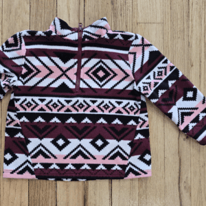 Fleece pullover with geometric tribal patterns in black, white, and maroon.