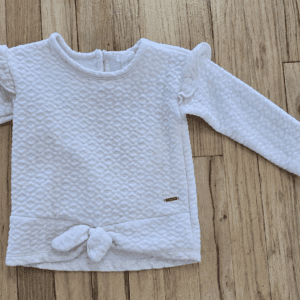 White textured long-sleeve baby sweater with bow detail.