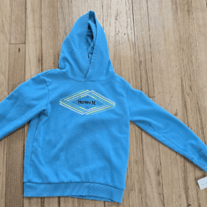 Blue hoodie with a geometric design on the front.