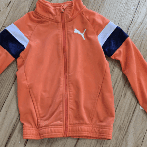 Orange Puma jacket with navy and white stripes on sleeves.