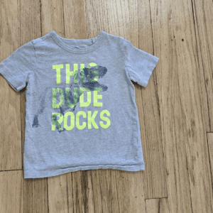 Gray toddler T-shirt with neon green text and black stains.
