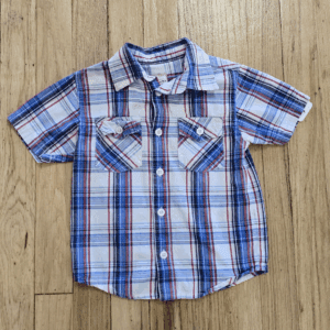Blue and white plaid short-sleeve shirt on wooden floor.