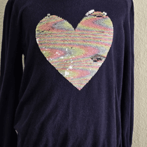 Navy blue sweater with a large, colorful sequined heart design.
