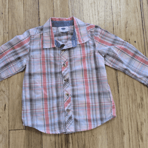 A child's long-sleeve plaid shirt with red, white, and gray colors.