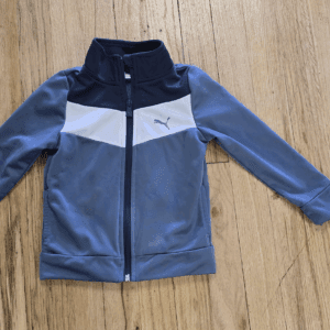 A blue and gray Nike zip-up jacket for kids.